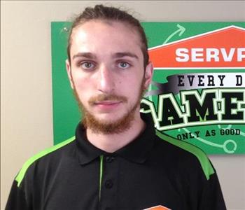 Nick's Production Picture, male employee in front of SERVPRO logo
